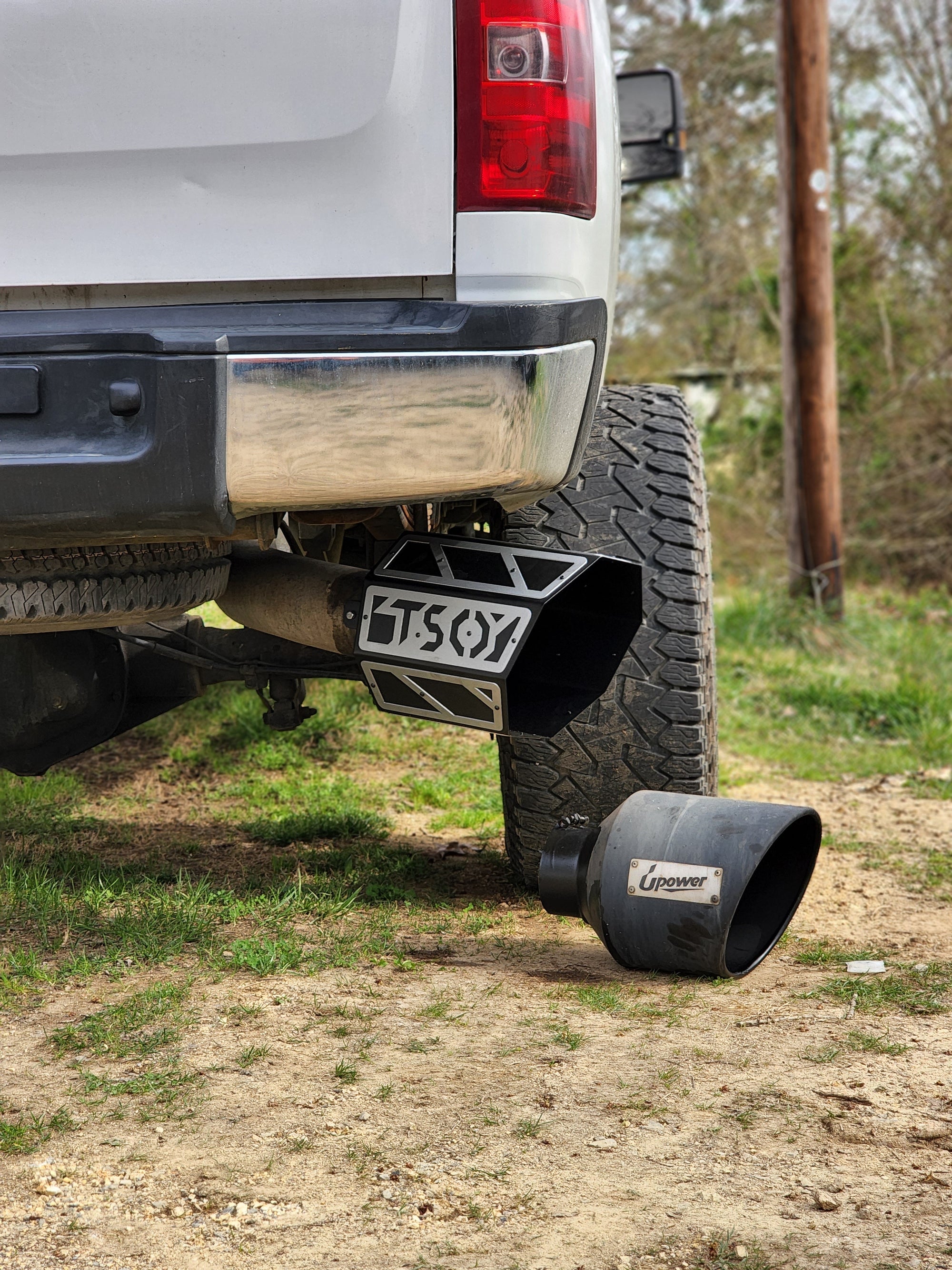 8" TSO Octagon Overlay Exhaust Tip on a Duramax next to a a round exhaust tip